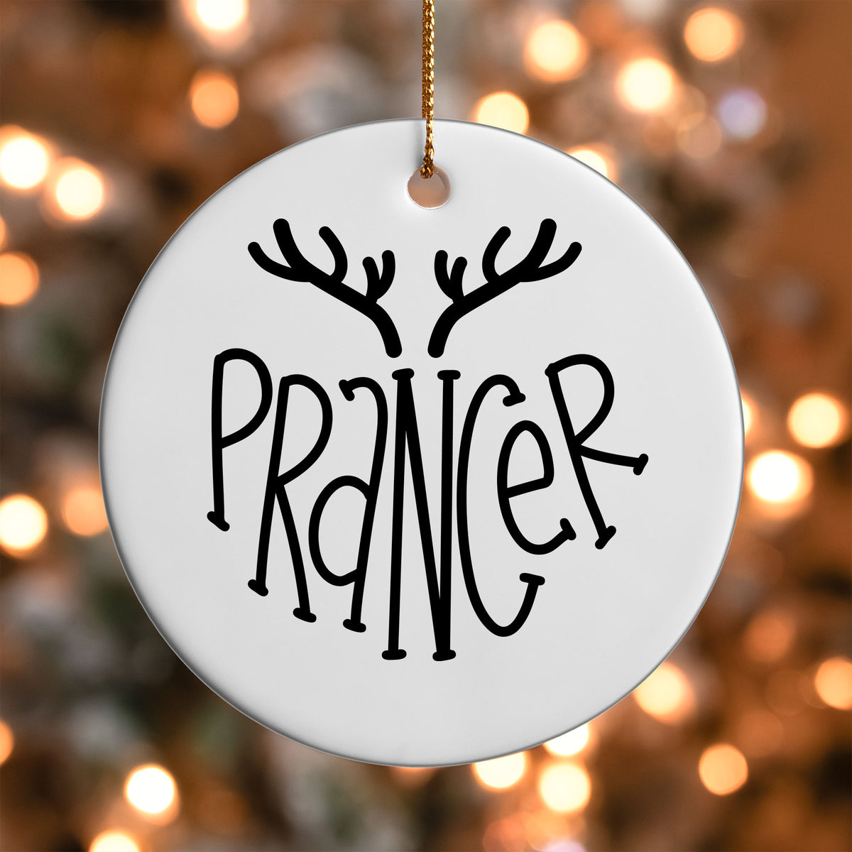 Prancer Reindeer Name ornament UV DTF transfer on a round white ornament with a bokeh light background
