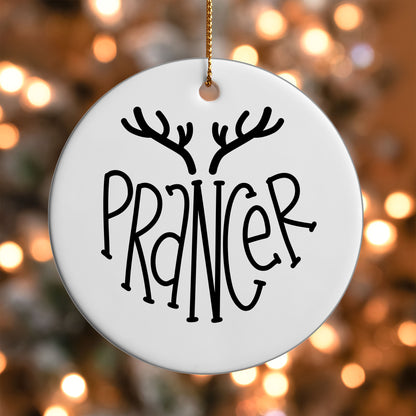 Prancer Reindeer Name ornament UV DTF transfer on a round white ornament with a bokeh light background