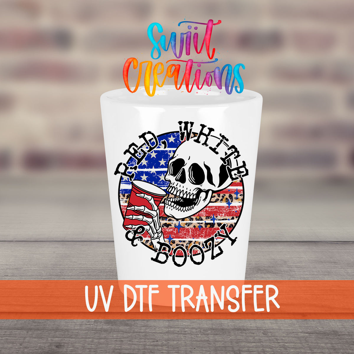 Red White and Boozy UV DTF transfer on a white shot glass in front of a brick wall