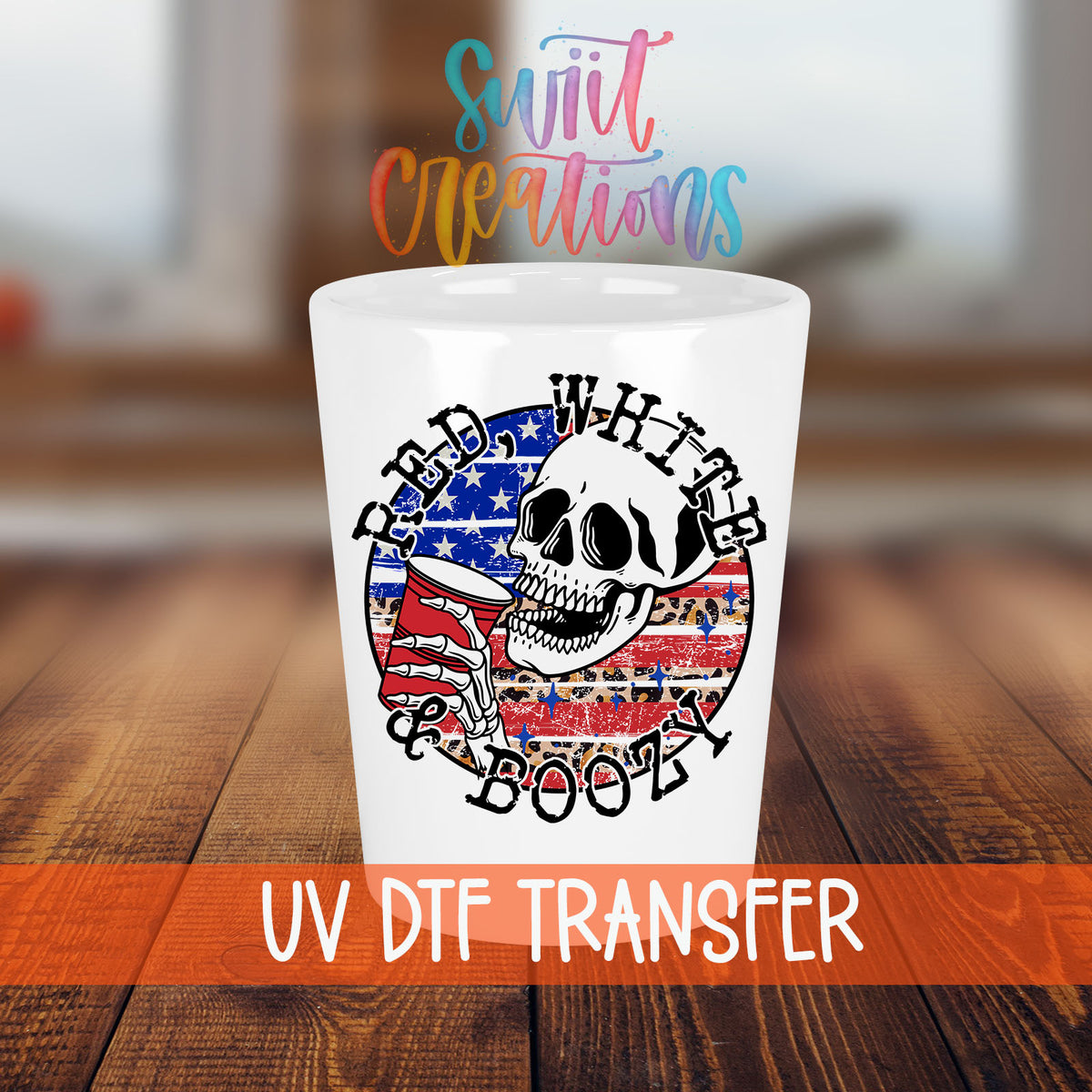Red White and Boozy shot glass transfer on a white shot glass on a wooden table