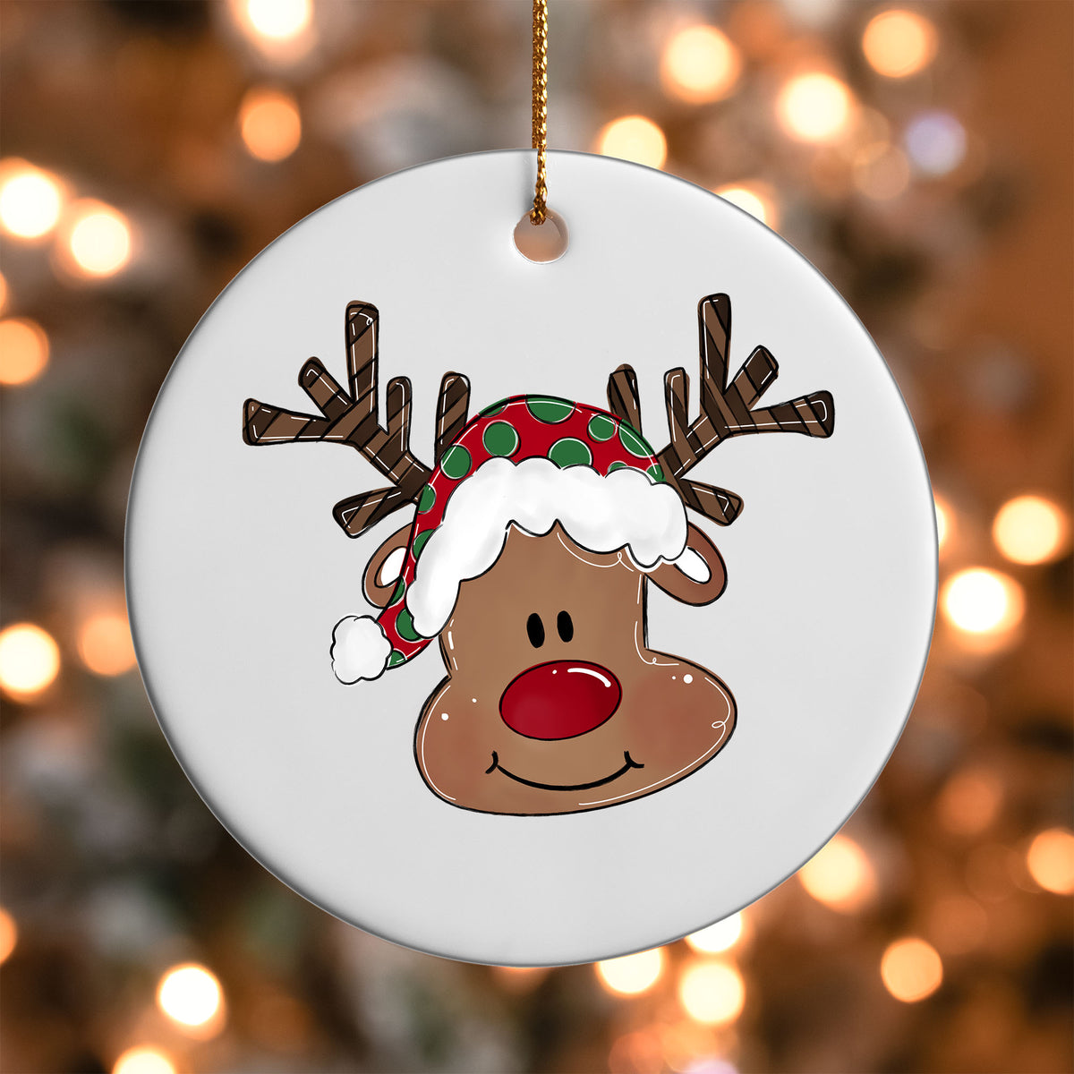 Reindeer Face in Santa Hat ornament UV DTF transfer on a round white ornament with a bokeh light background