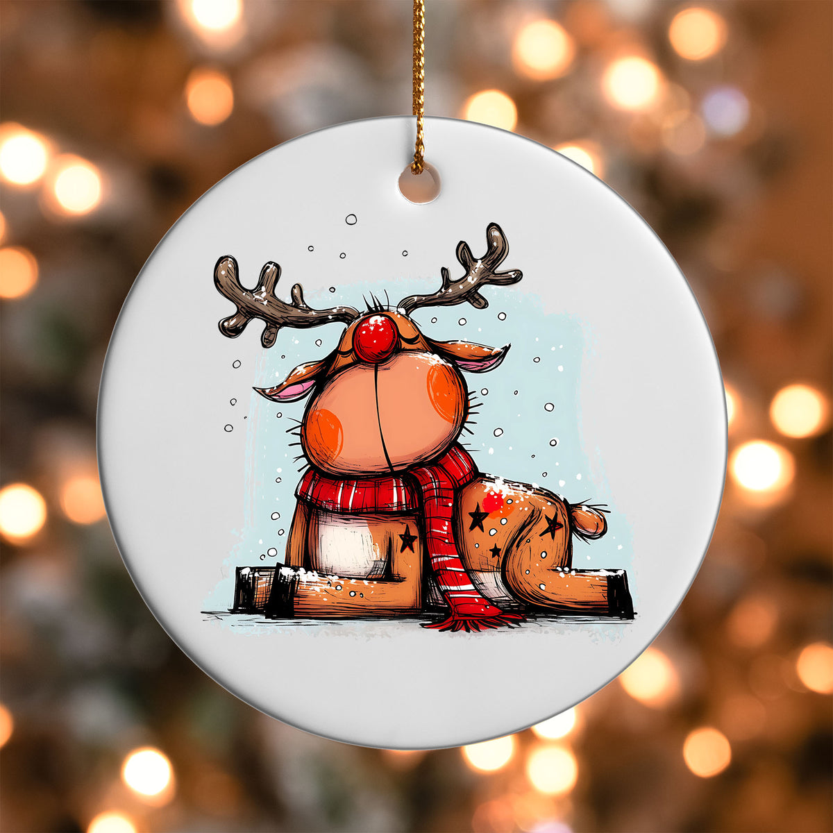 Reindeer Lying in the Snow ornament UV DTF transfer on a round white ornament with a bokeh light background