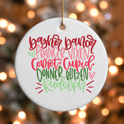 Reindeer Names ornament UV DTF transfer on a round white ornament with a bokeh light background