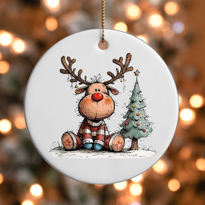 Reindeer Sitting by a Tree ornament UV DTF transfer on a round white ornament with a bokeh light background