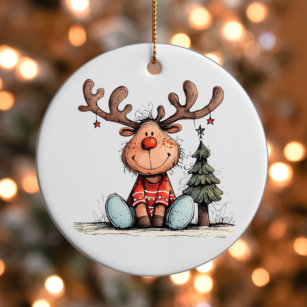 Reindeer Sitting in the Snow ornament UV DTF transfer on a round white ornament with a bokeh light background