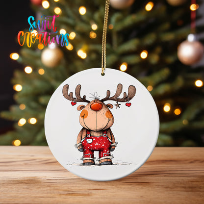 Reindeer with Hanging Hearts ornament UV DTF transfer on an ornament on a wooden table with tree lights behind it