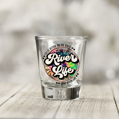 Close-up of the River Life UV DTF transfer on a clear shot glass