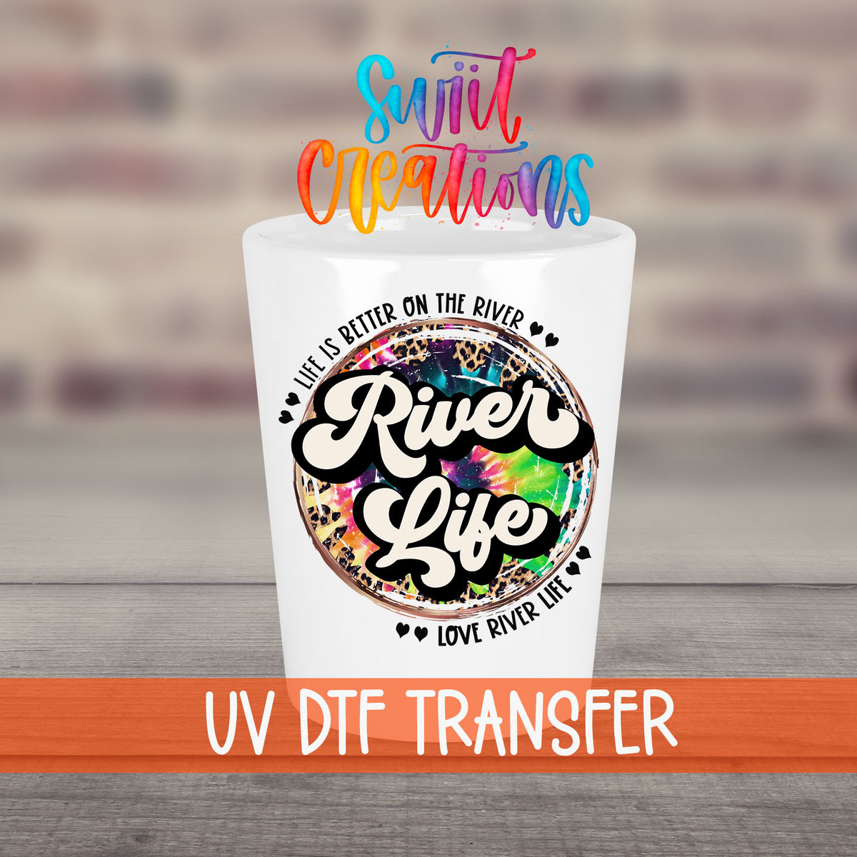 River Life UV DTF transfer on a white shot glass in front of a brick wall