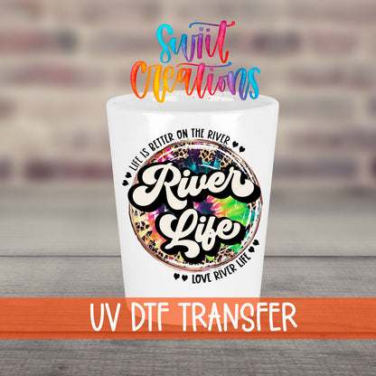 River Life UV DTF transfer on a white shot glass in front of a brick wall