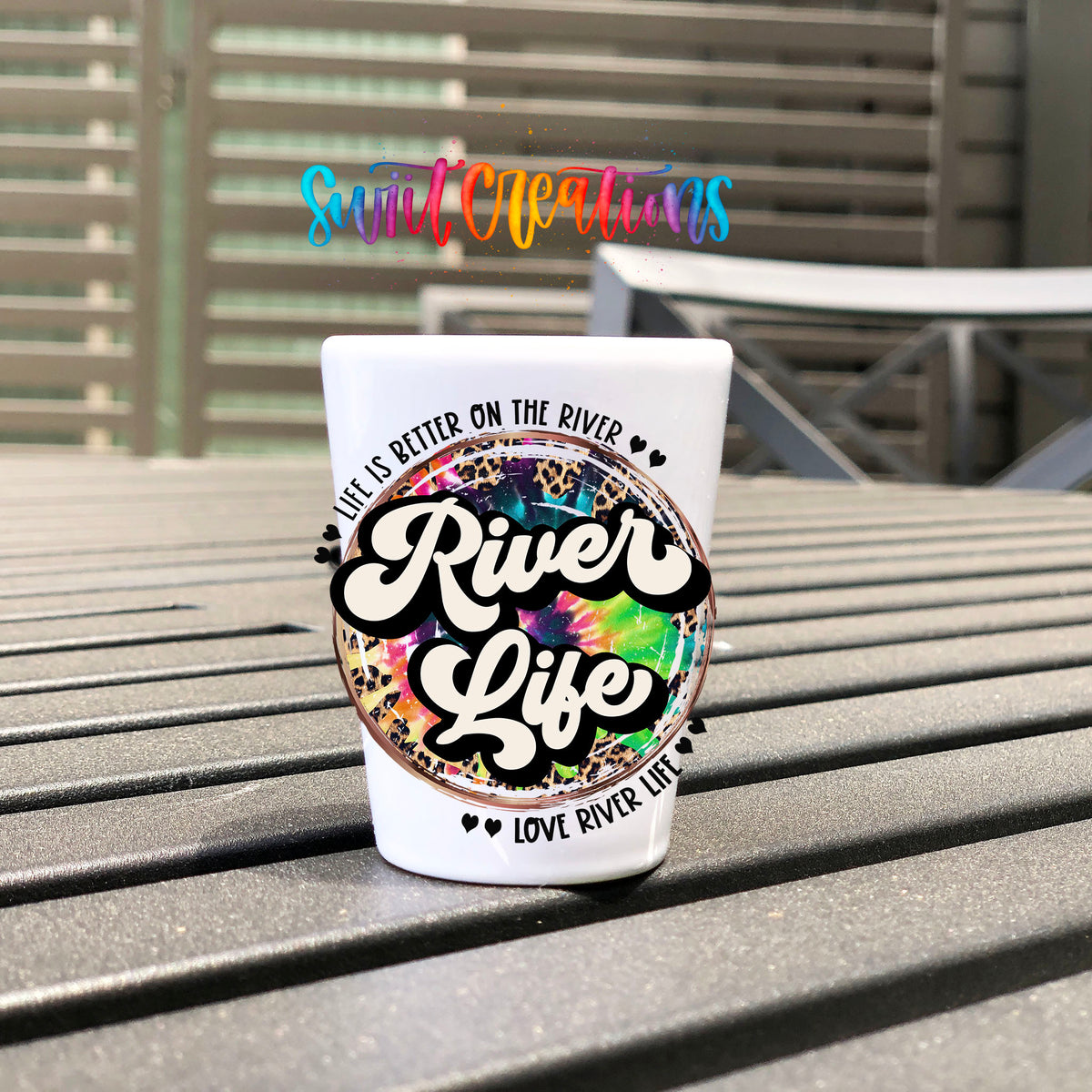 River Life UV DTF transfer on a white shot glass on an outdoor patio table