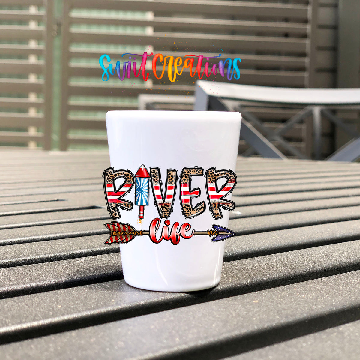 River Life USA UV DTF transfer on a white shot glass on an outdoor patio table
