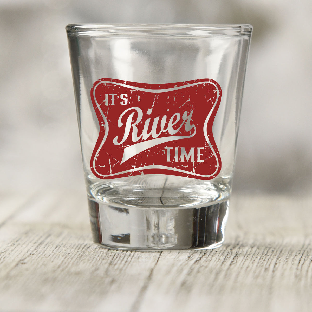 River Time shot glass UV DTF transfer with distressed vintage badge on a clear shot glass