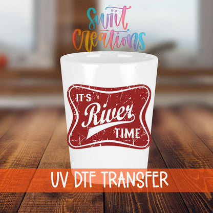 River Time shot glass transfer on a white shot glass on a wooden table