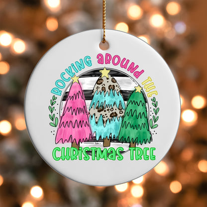Rocking Around the Christmas Tree ornament UV DTF transfer on a round white ornament with a bokeh light background