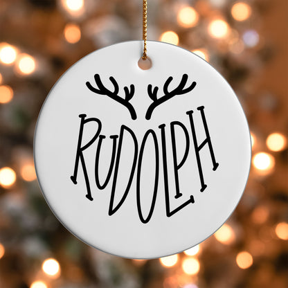 Rudolph Reindeer Name ornament UV DTF transfer on a round white ornament with a bokeh light background