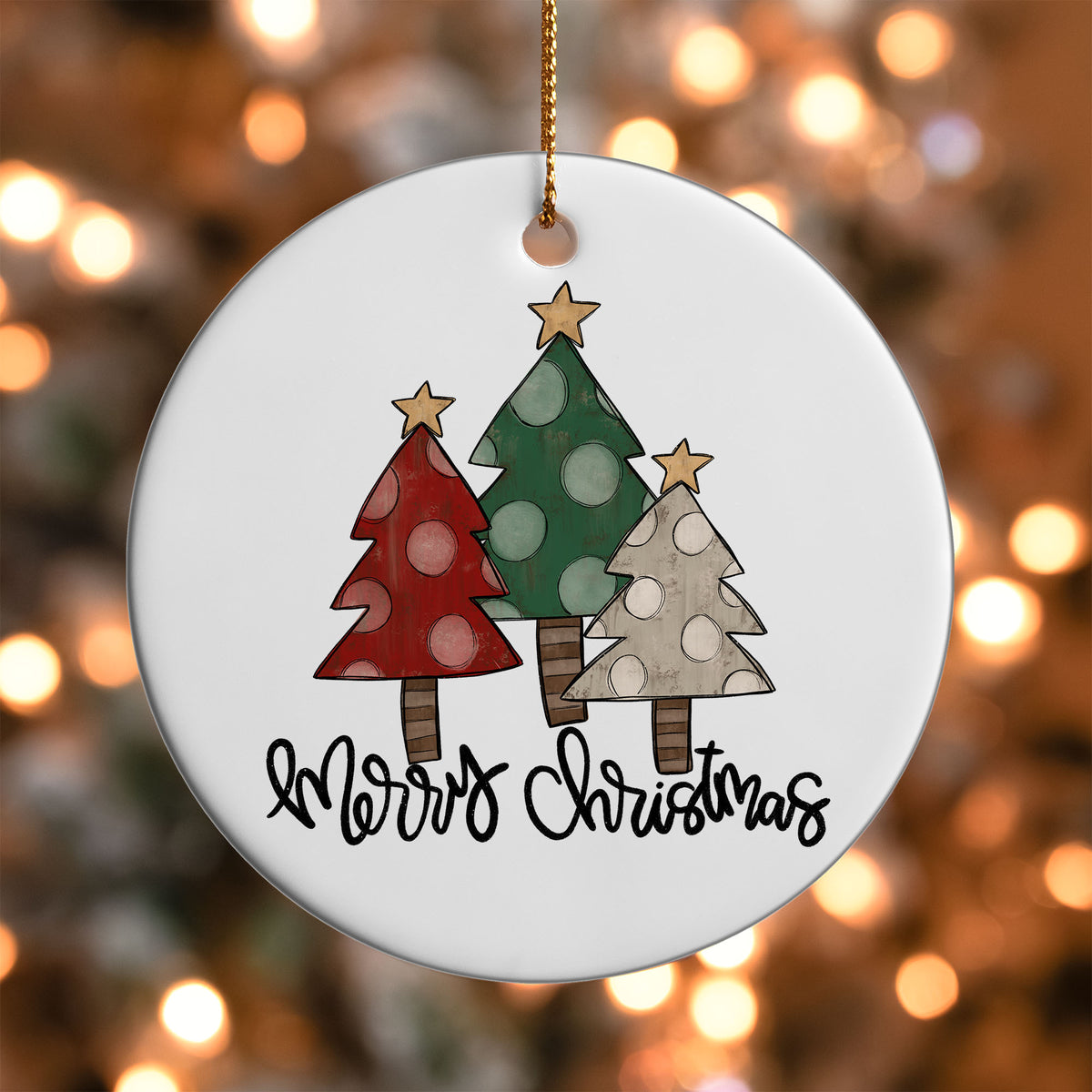 Rustic Tree Trio Merry Christmas ornament UV DTF transfer on a round white ornament with a bokeh light background