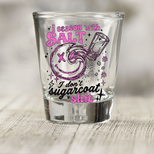 Salt Season Adult Humor shot glass UV DTF transfer with smiley face, salt shaker, and sparkle details on a clear shot glass