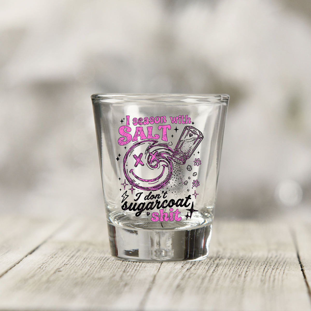 Close-up of the Salt Season Adult Humor UV DTF transfer on a clear shot glass