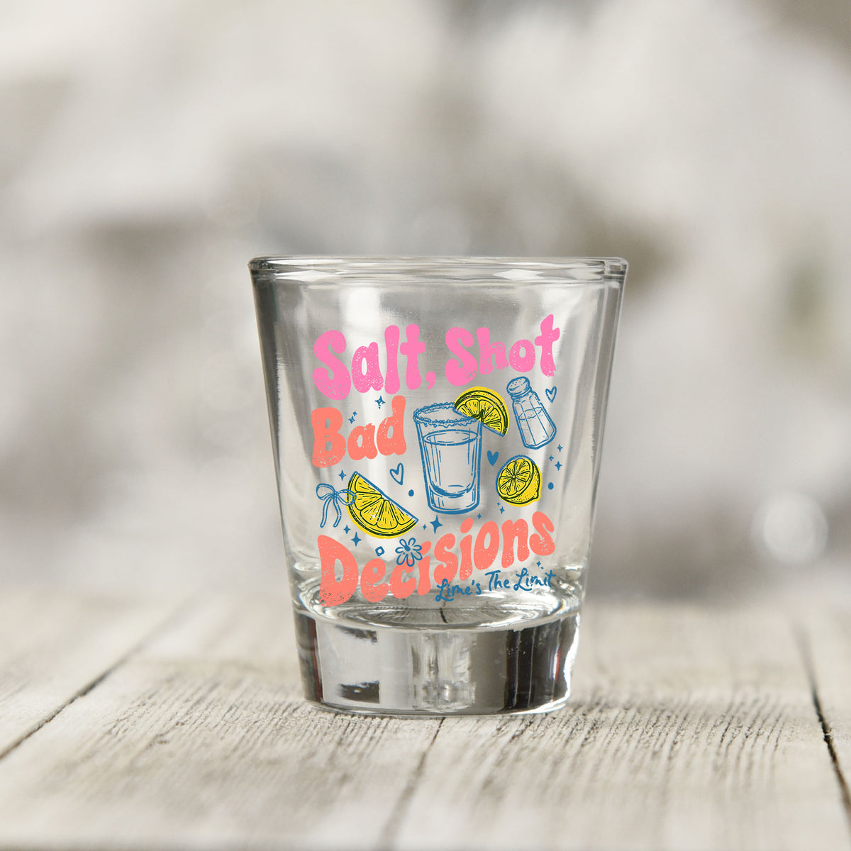 Close-up of the Salt Shot Bad Decisions UV DTF transfer on a clear shot glass