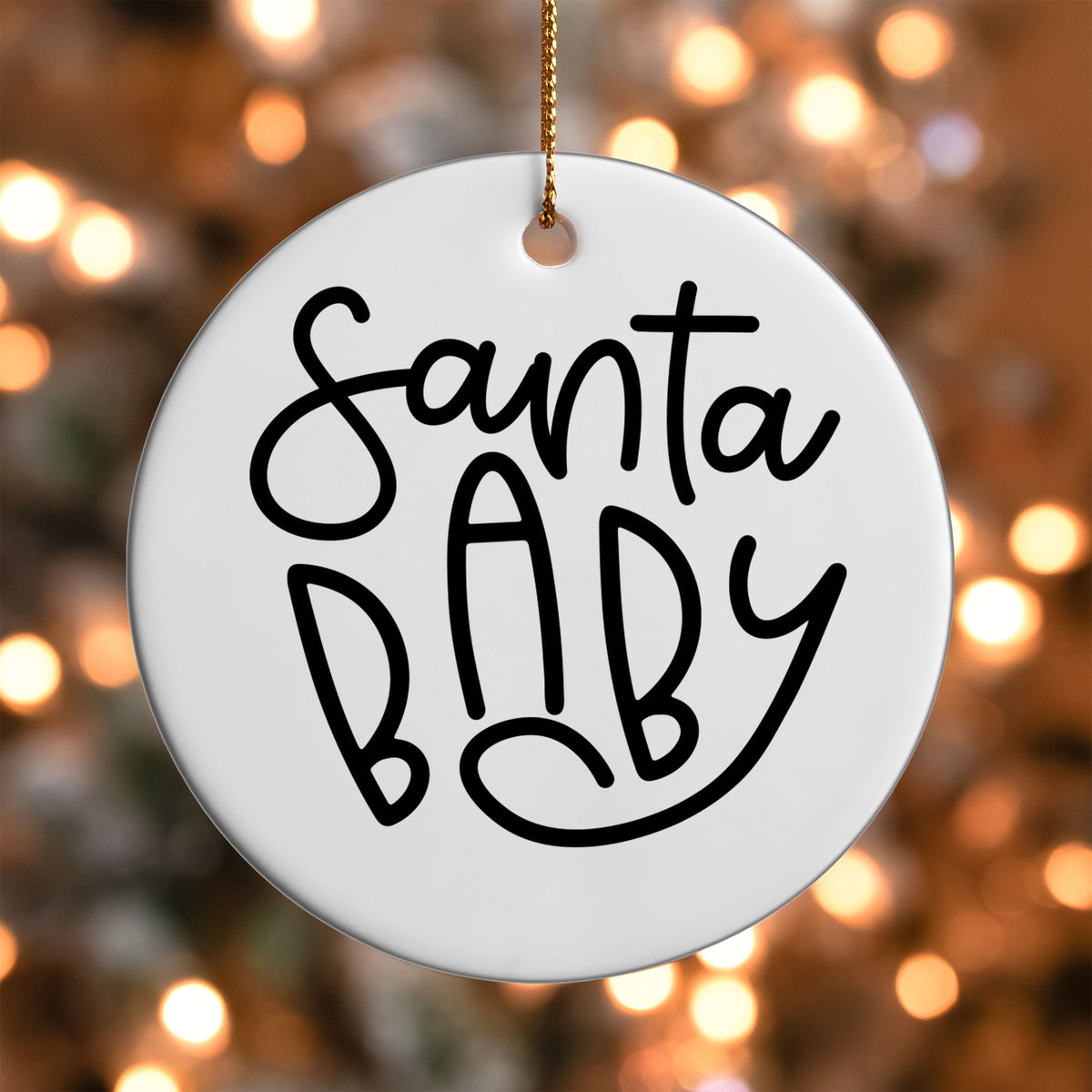Santa Baby ornament UV DTF transfer on a round white ornament with a bokeh light background