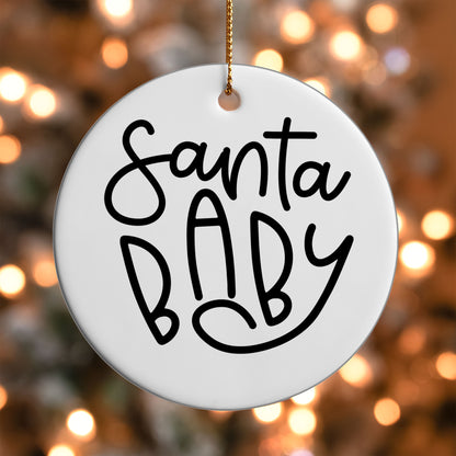 Santa Baby ornament UV DTF transfer on a round white ornament with a bokeh light background