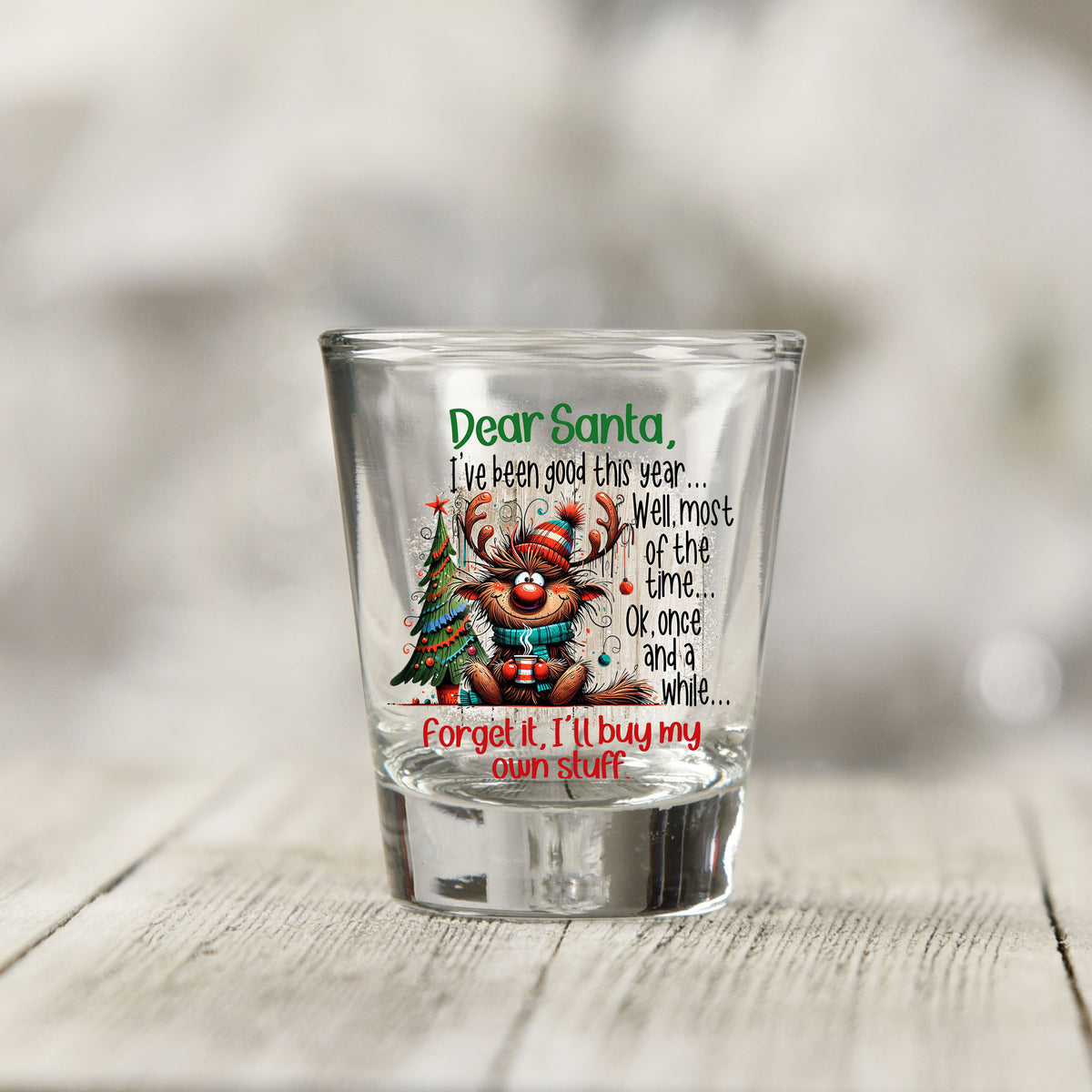 Close-up of the Santa I've Been Good Christmas UV DTF transfer on a clear shot glass