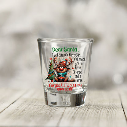 Close-up of the Santa I've Been Good Christmas UV DTF transfer on a clear shot glass