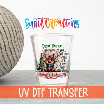 Santa I've Been Good Christmas UV DTF transfer on a clear shot glass with the Swiit Creations logo and UV DTF Transfer banner