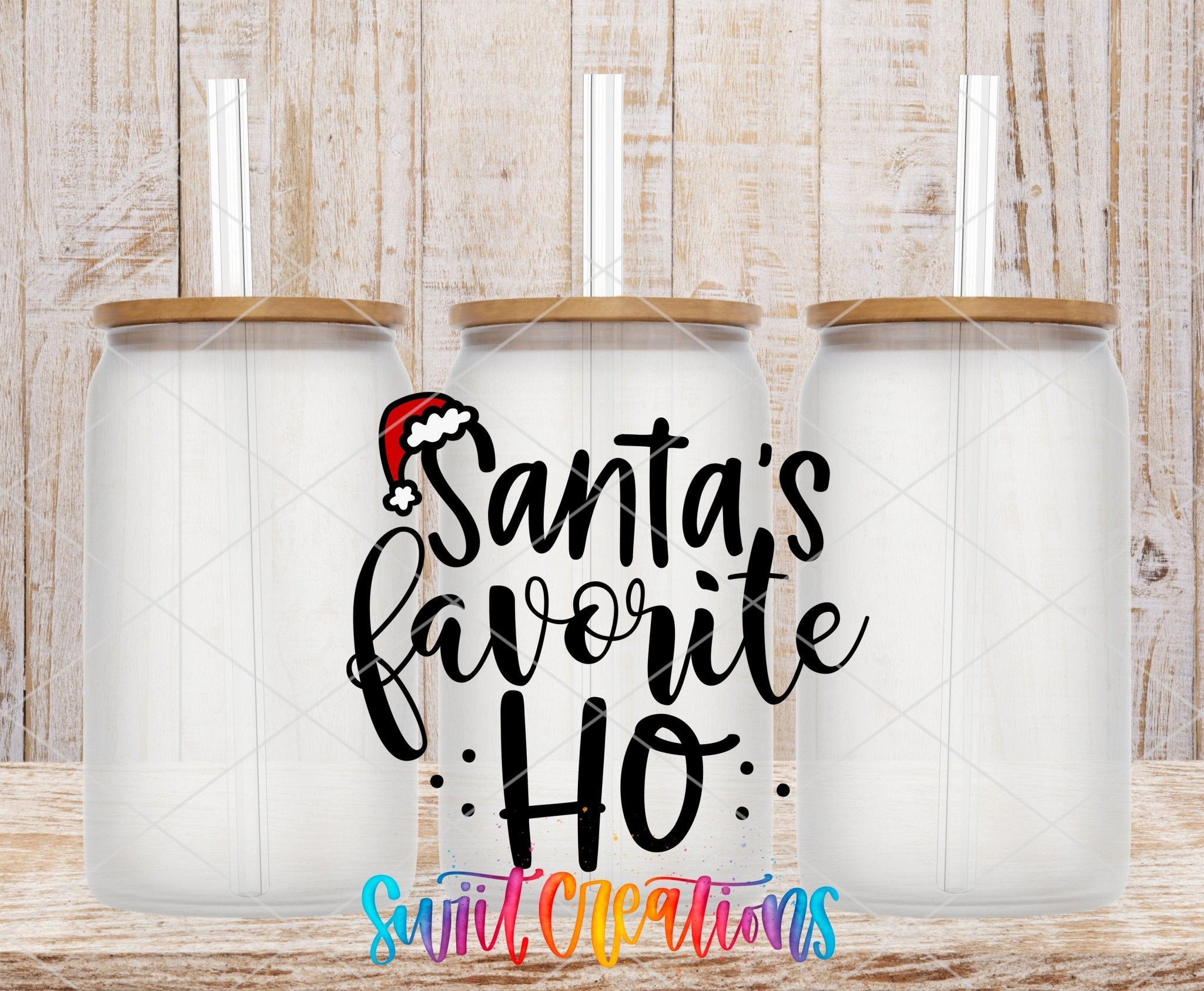 Swiit Creations UV DTF Santa’s Favorite Ho Christmas transfer shown on a clear glass can set