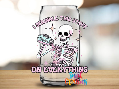 Close-up of the I Sprinkle This Stuff on Everything UV DTF transfer on a clear glass can