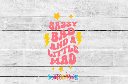 Sassy Bad and a Little Mad UV DTF transfer artwork on a gray wood background