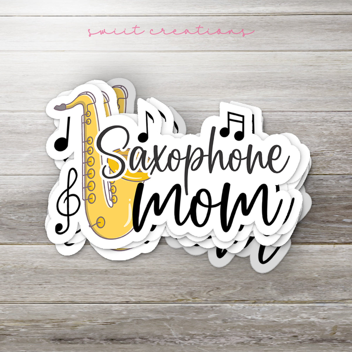 Stack of Saxophone Mom glossy stickers on a gray wood table