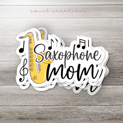 Stack of Saxophone Mom glossy stickers on a gray wood table