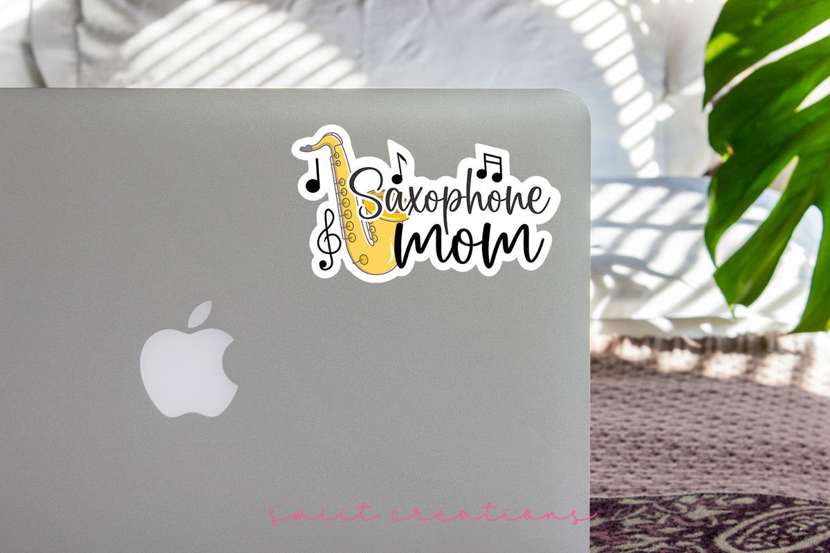 Saxophone Mom sticker on the lid of a silver laptop