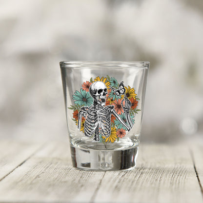 Close-up of the Skeleton Floral UV DTF transfer on a clear shot glass