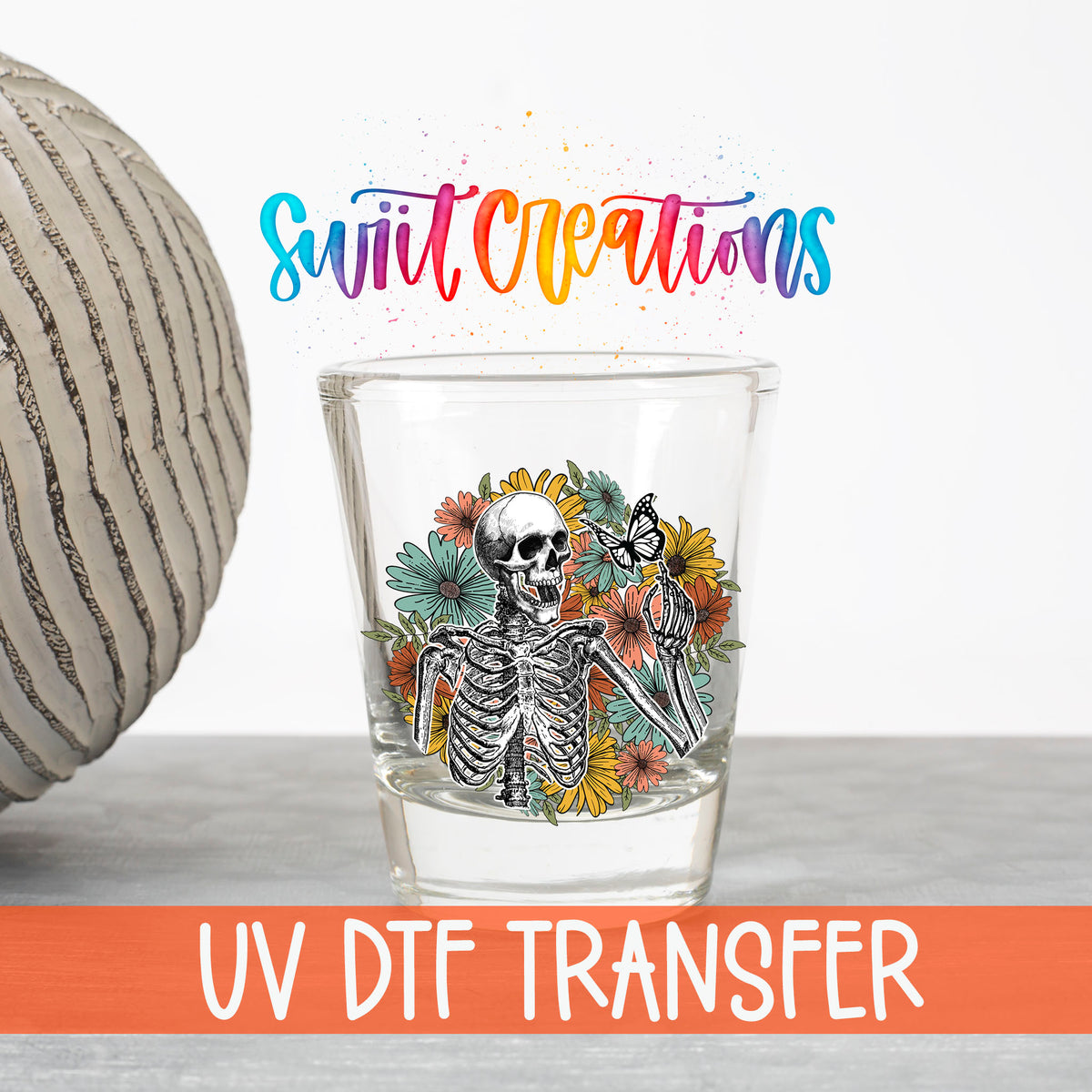 Skeleton Floral UV DTF transfer on a clear shot glass with the Swiit Creations logo and UV DTF Transfer banner