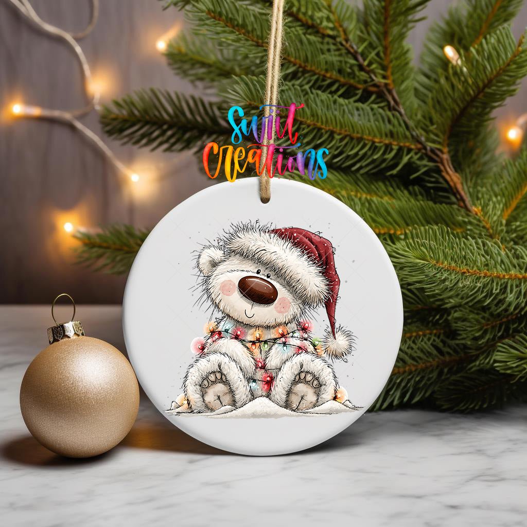 Sledding White Bear ornament UV DTF transfer on a hanging ornament with pine branches and a gold bauble