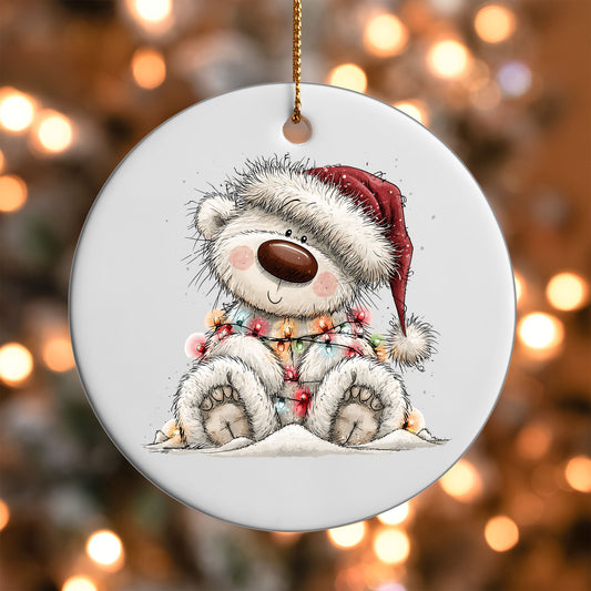 Sledding White Bear ornament UV DTF transfer on a round white ornament with a bokeh light background