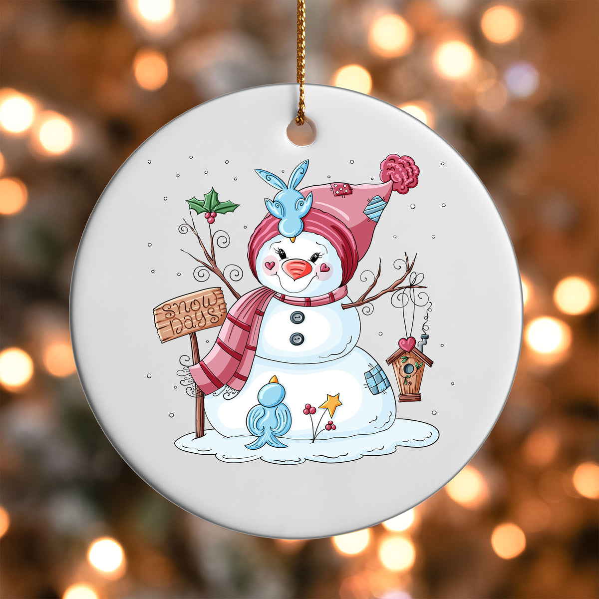 Snow Days Snowman ornament UV DTF transfer on a round white ornament with a bokeh light background