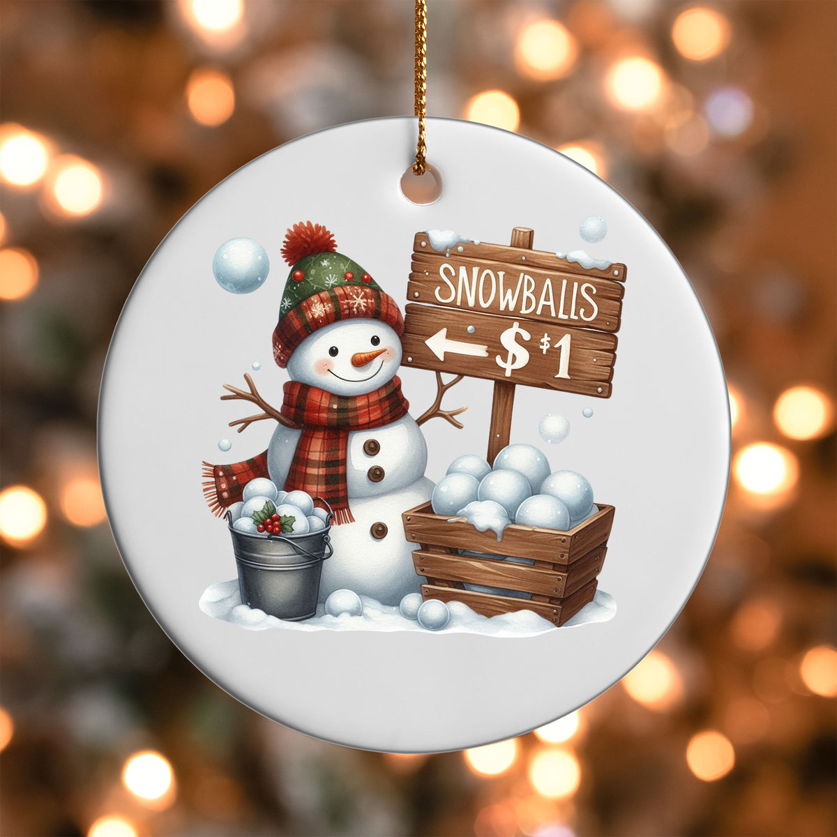 Snowballs for Sale Snowman ornament UV DTF transfer on a round white ornament with a bokeh light background