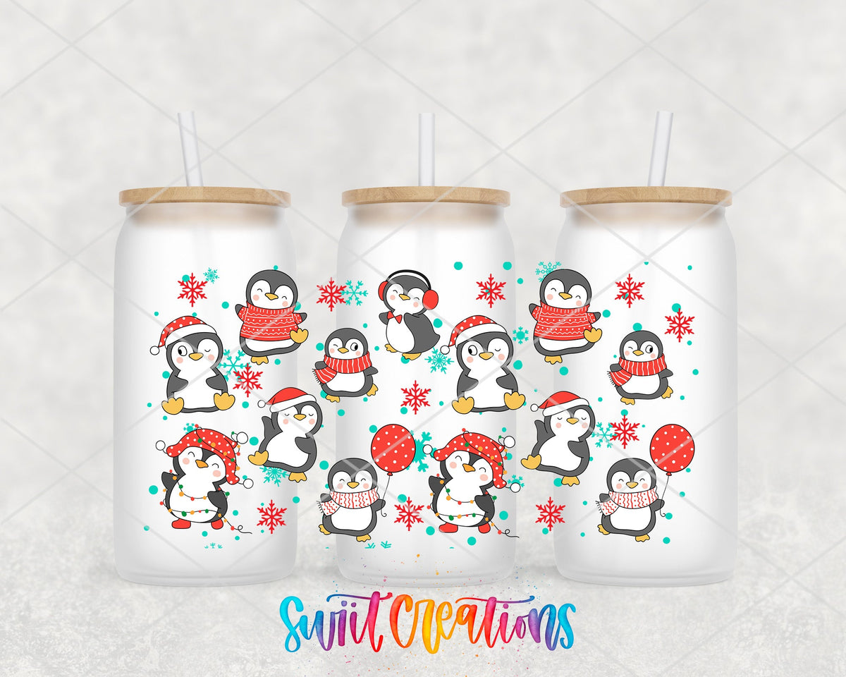 Christmas Penguins UV DTF wrap on three frosted glass cans