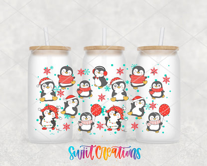 Christmas Penguins UV DTF wrap on three frosted glass cans
