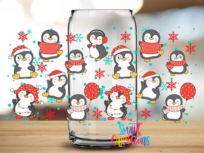 Close-up of the Christmas Penguins UV DTF wrap on a clear glass can