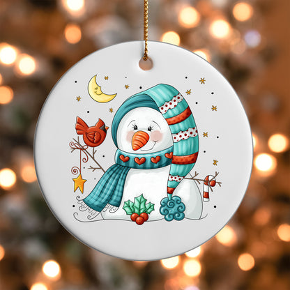 Snowman and Cardinal ornament UV DTF transfer on a round white ornament with a bokeh light background