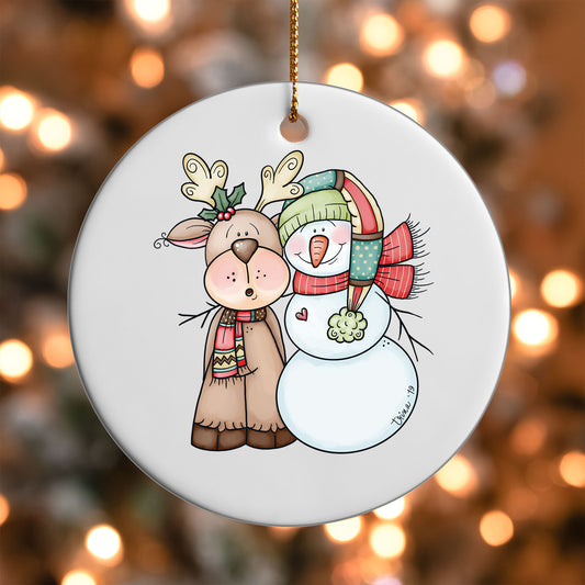 Snowman and Reindeer Friends ornament UV DTF transfer on a round white ornament with a bokeh light background
