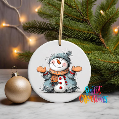 Snowman with Open Arms ornament UV DTF transfer on a hanging ornament with pine branches and a gold bauble