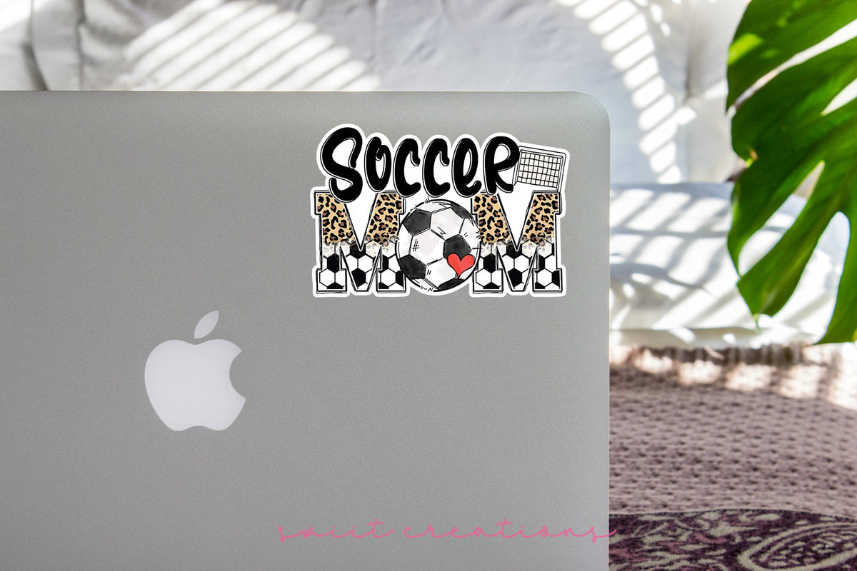 Soccer Mom sticker on the lid of a silver laptop