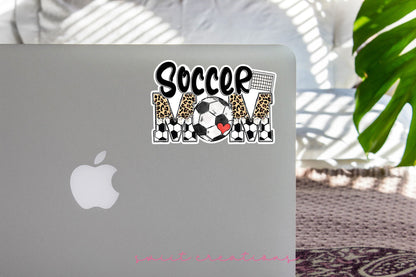 Soccer Mom sticker on the lid of a silver laptop