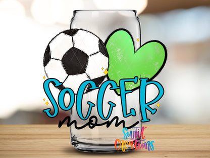 Close-up of the Soccer Mom blue letters and green heart UV DTF wrap on a clear glass can