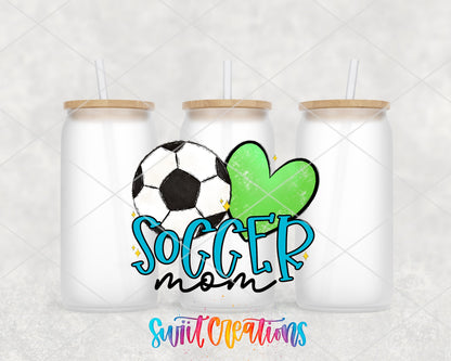 Soccer Mom blue letters and green heart UV DTF wrap on three frosted glass cans